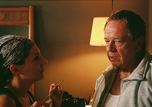 Yvonne Ortiz touches up the Bishop, Sam Anderson, on the set of Dirty Habit.